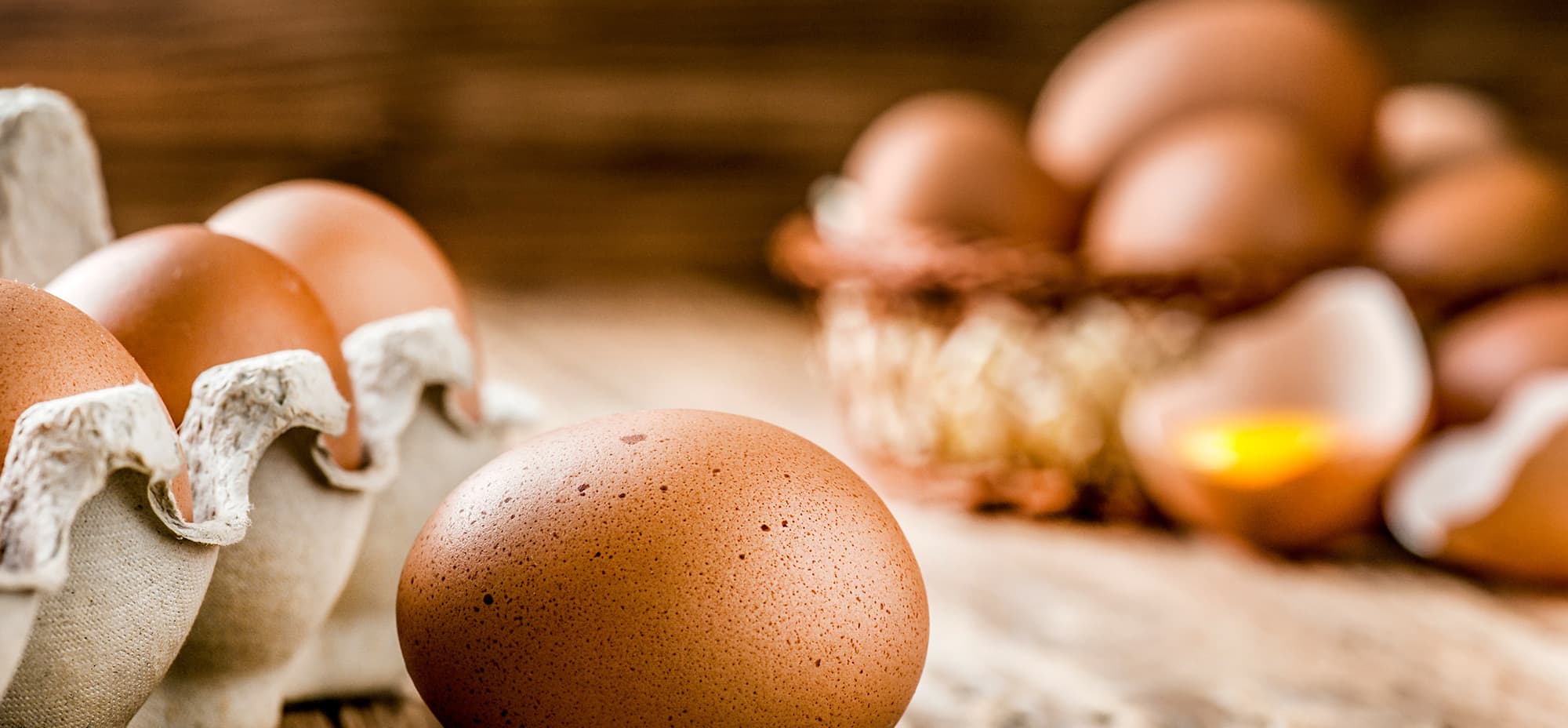 Image of a carton of eggs on a wooden board